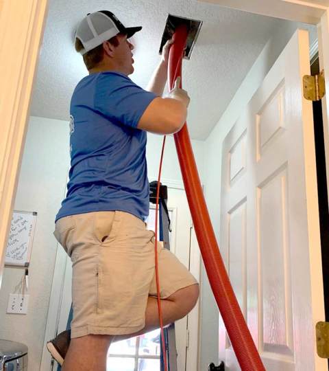 A technician at Firehouse Heating & Air using our sophisticated equipment to clean air ducts.